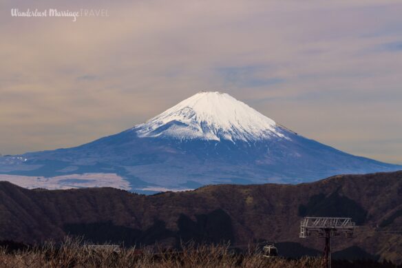 Photo of snow capped Mount Fuji with a cable car 