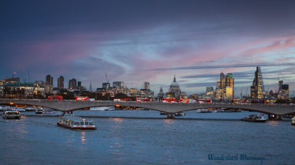 River with boats and skyline of churches and skyscrapers at dusk