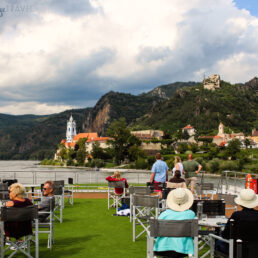 Passengers aboard Emerald Cruises' Emerald Destiny ship watching as we sail into Into Durnstein, Austria along the Danube River.