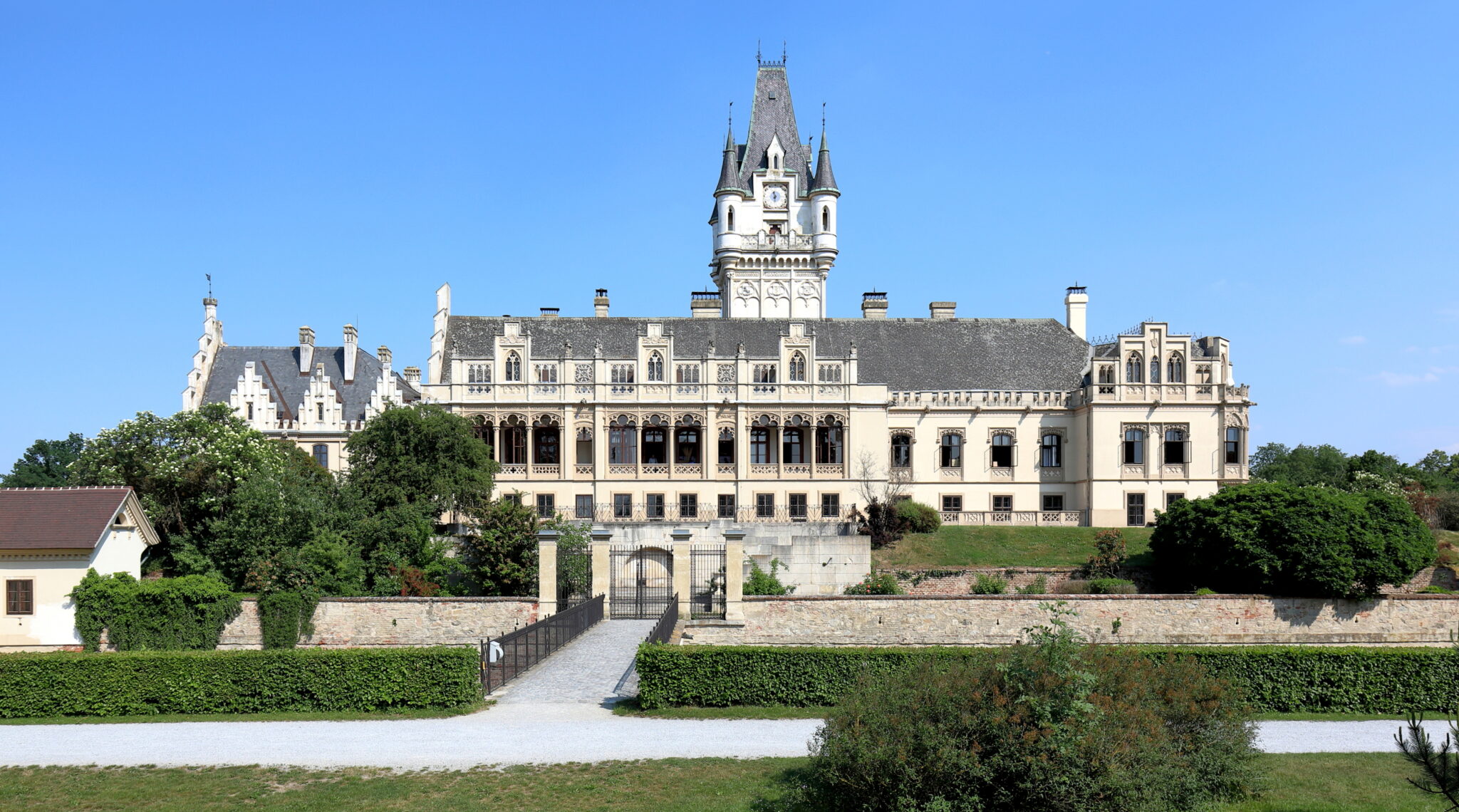 front view of Grafenegg Schloss, a large castle with a tower and its gardens