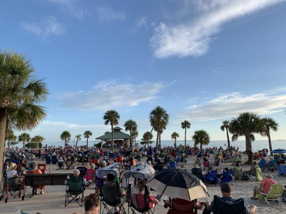 lots of people and palm trees for the Sunset Beach Concert Series in Tarpon Springs 