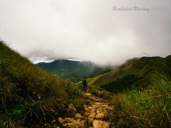 Alex hiking a trail in Valle de Anton, as clouds pass in the rain forest.