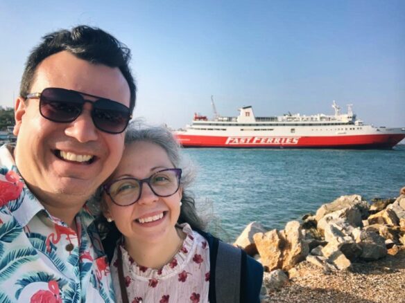 Alex and Bell standing in front of a Fast Ferries ship docked in Rafina, Greece