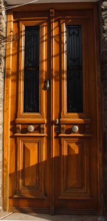 Amber colored door with a hand knocker