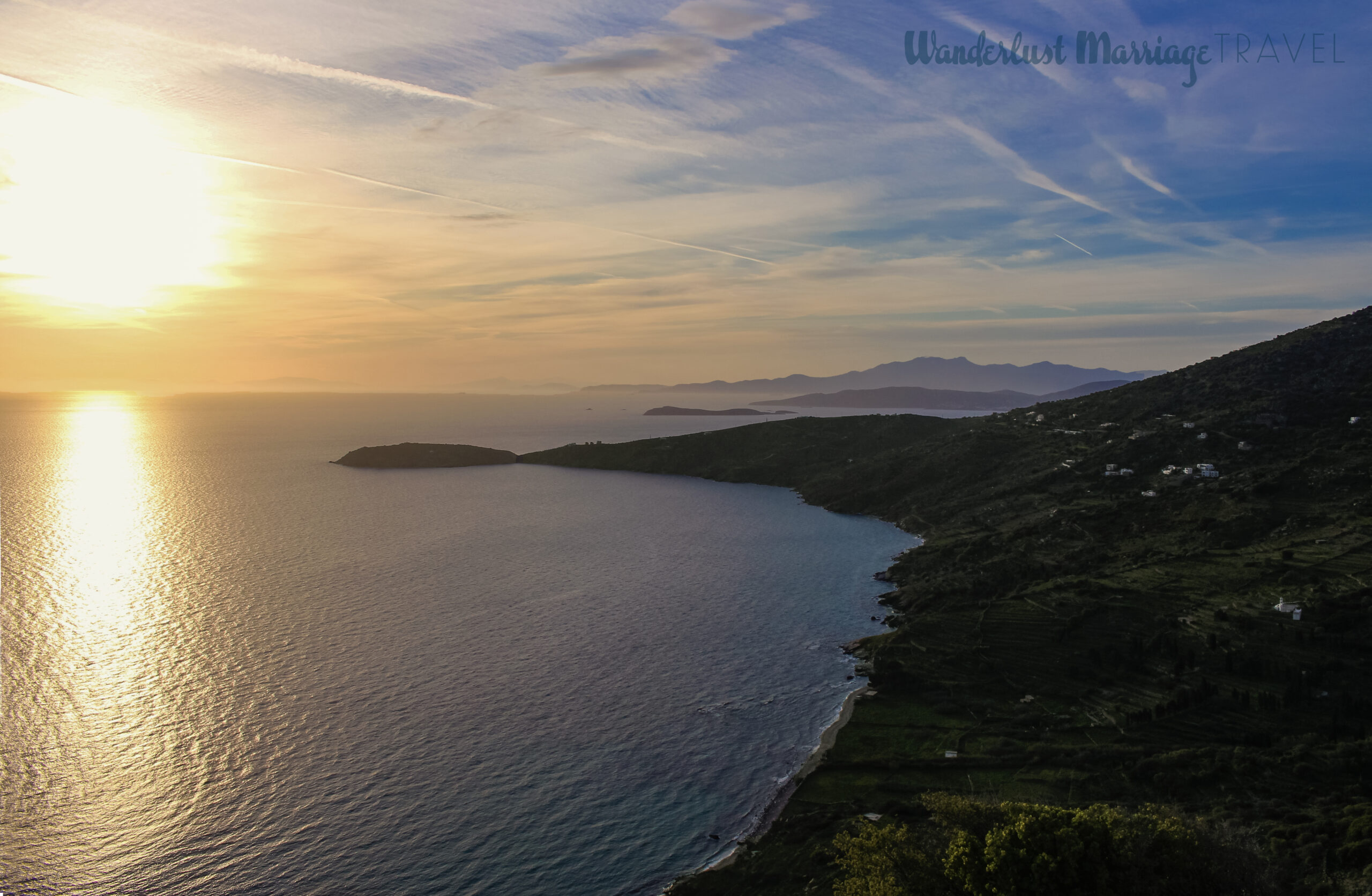 Sun starting to set over the island, the sky looks golden and is reflected on the sea