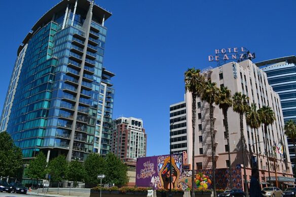 Several tall buildings and a colorful mural in downtown San Jose, California