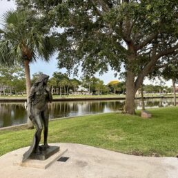 The Craig Park Mermaid Statue and trees along the Bayou in Tarpon Springs, Florida.