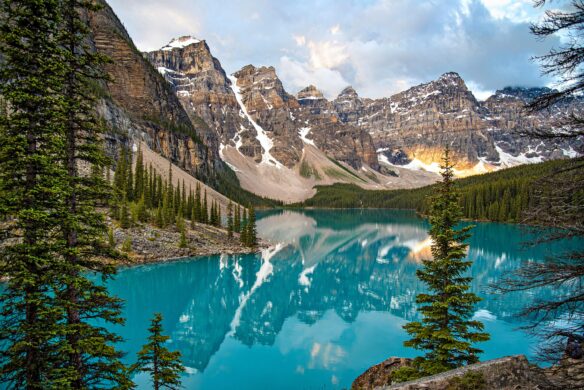 The mountains reflect off Lake Louise in Banff National Park, Alberta, Canada.