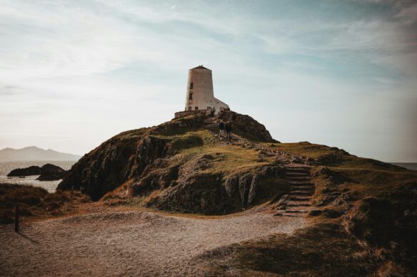 Ynys Llanddwyn lighthouse in Anglesey, North Wales, with a cloudy sky