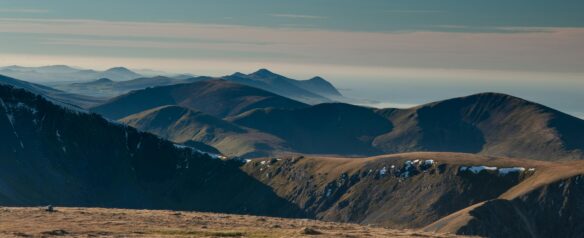 Mountains in Snowdonia National Park with subtle light in the sky.