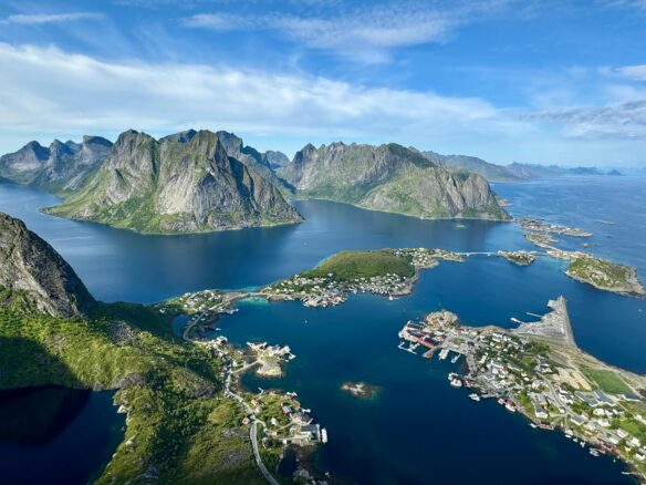Majestic Norwegian fjords tower over blue water in Reine, Norway