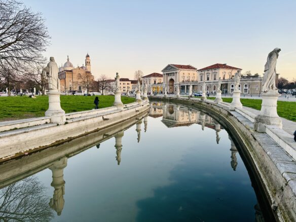 Two columns of statues line opposite sides of the canal at Prato della Valle in Padova, Italy.