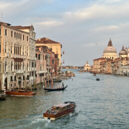 Boats pass through a Venice canal