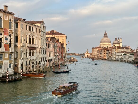 Boats pass through a Venice canal