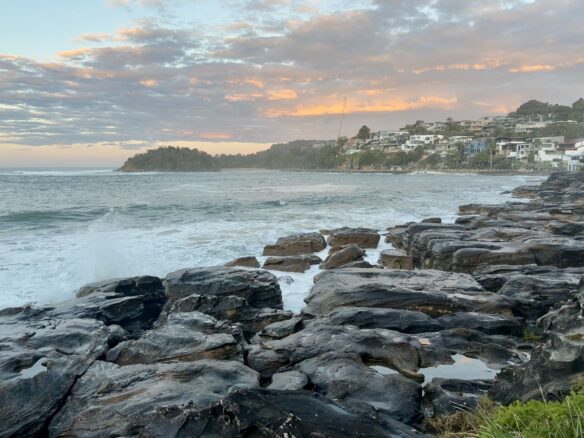 Waves crash along the rocks at sunset in Manly, just a short ferry ride from Sydney's CBD.