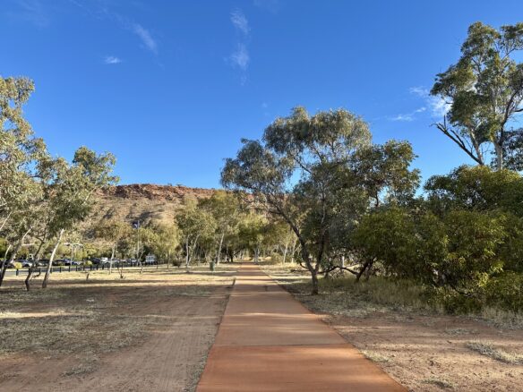 A picturesque red hued sidewalk in the Dessert Springs area of Alice Springs, in the Northern Territory.