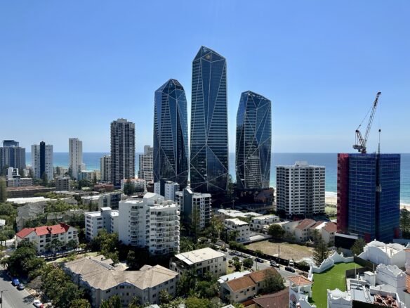 Modern glass skyscraper hotels and condominiums along with other buildings line the beach in Surfers Paradise, Queensland.