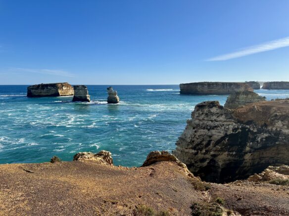 Jutting rock formations rise from the sea in Bay of Islands Coastal Park along the Great Ocean Road in Victoria, Australia.