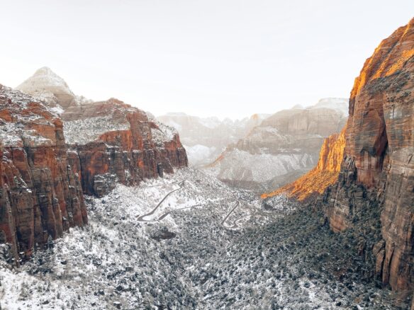 Snow blankets Zion National Park with a grey sky overhead
