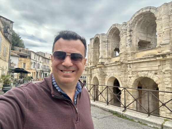 Alex outside Arles Arena with a cloudy sky overhead.