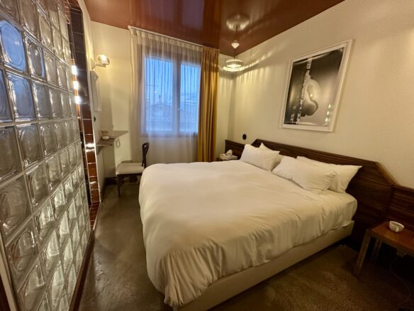 1970's themed room at Hotel Present in Arles, France features a plush bed.