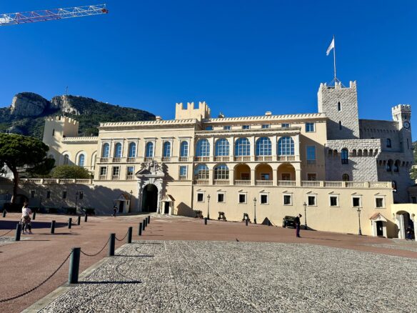 Front entrance of The Prince's Palace of Monaco on a quiet day with a clear blue sky above. 