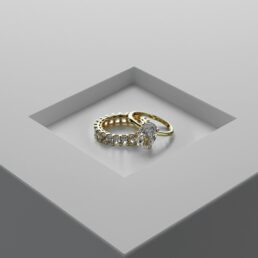 Two gold and diamond rings atop each other.