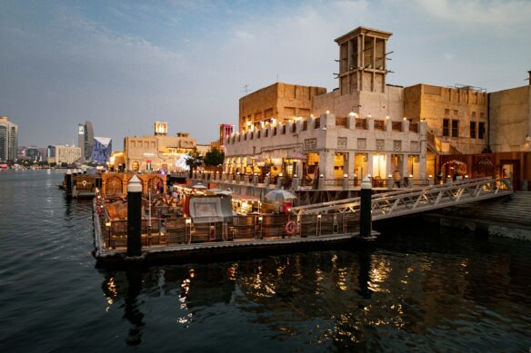 Dubai Creek at dawn, with old buildings lit up