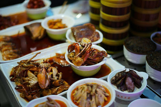 A variety of different Asian plates and bowls, including seafood dishes.