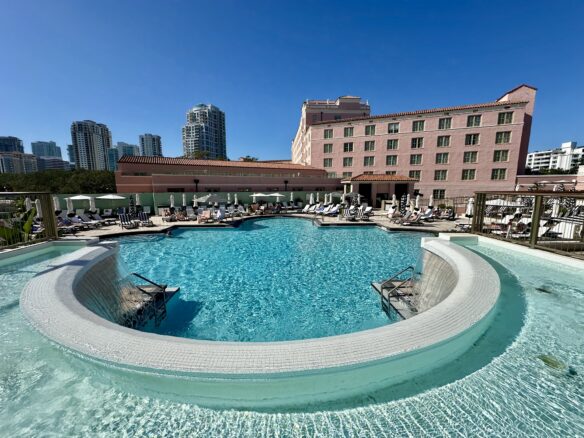 A circular pool at Vinoy Resort with a view of downtown St. Petersburg in the background.