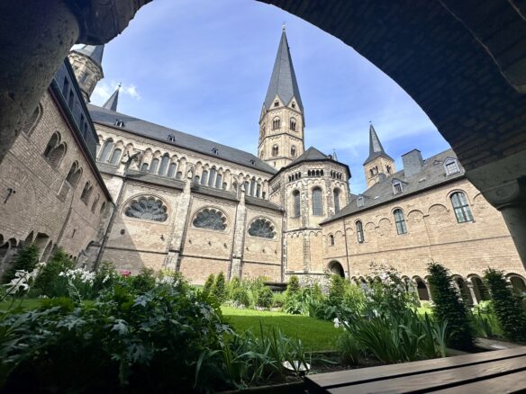 The cloister of Bonn Minster with a blue sky overhead