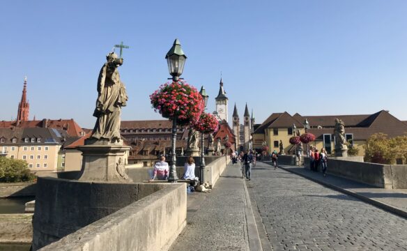 View of the historic center from the Old Main Bridge in Würzburg, which is lined with impressive statues of saints.