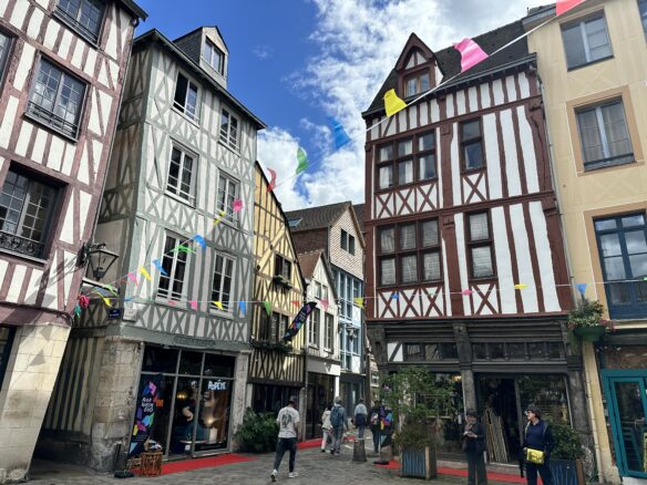 Colorful half timbered merchant buildings in Rouen, France housing a variety of businesses