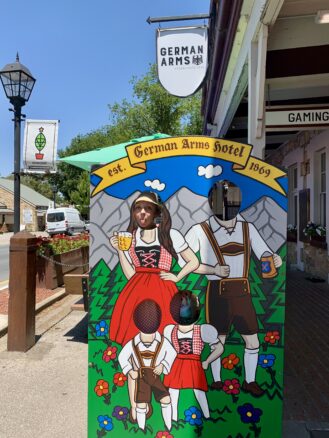 Bell of Wanderlust Marriage Travel sticks her head out of a German cutout in Hahndorf, South Australia