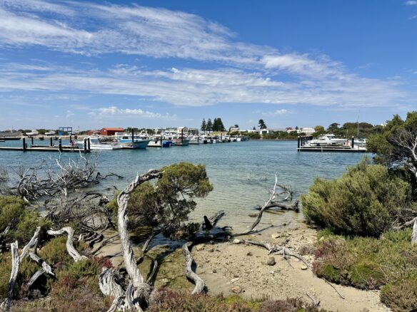 The marina in Robe, South Australia, with a partly cloudy blue sky.
